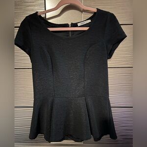 Ricki’s S black peplum top with zipper detail at back